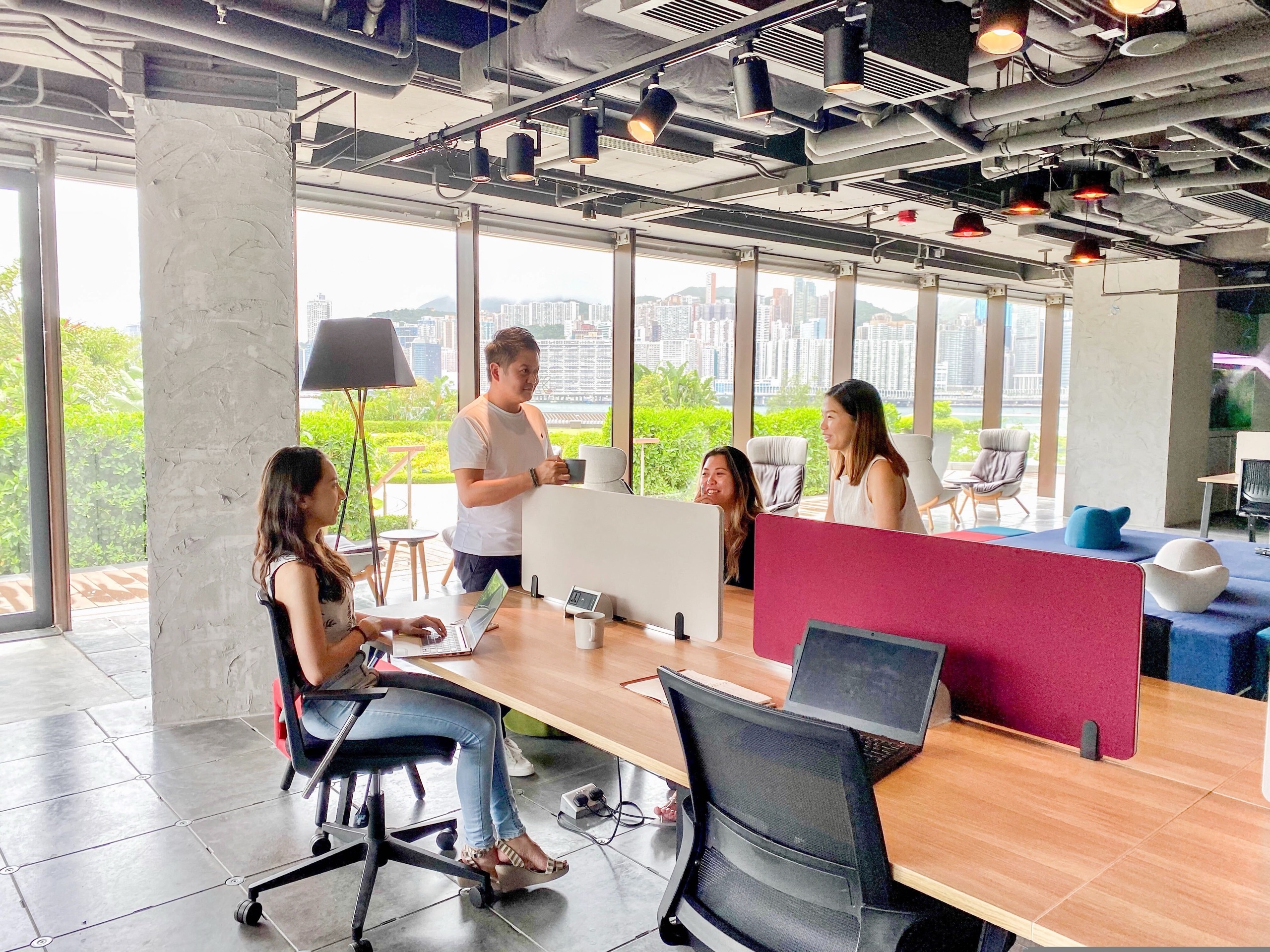 Base members working together at the Kerry Hotel coworking space in Hong Kong